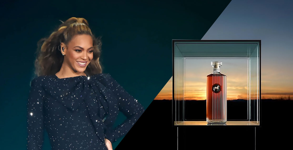 Beyonce Standing next to her new rye whisky SirDavis enclosed in a glass box.