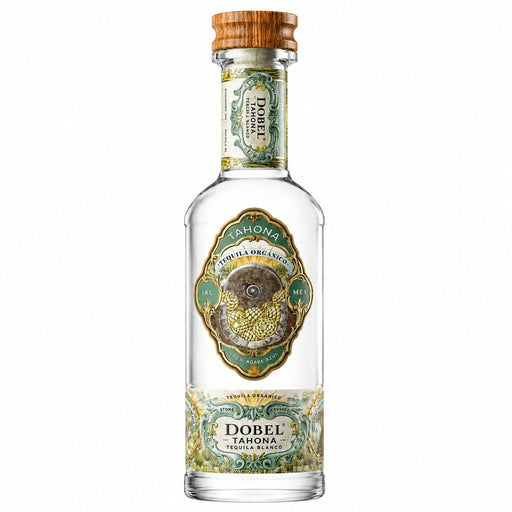 A bottle of Dobel Tahona Tequila Agave Reserve, featuring a clear glass bottle with a light brown wooden cap, and ornate green and gold labels.