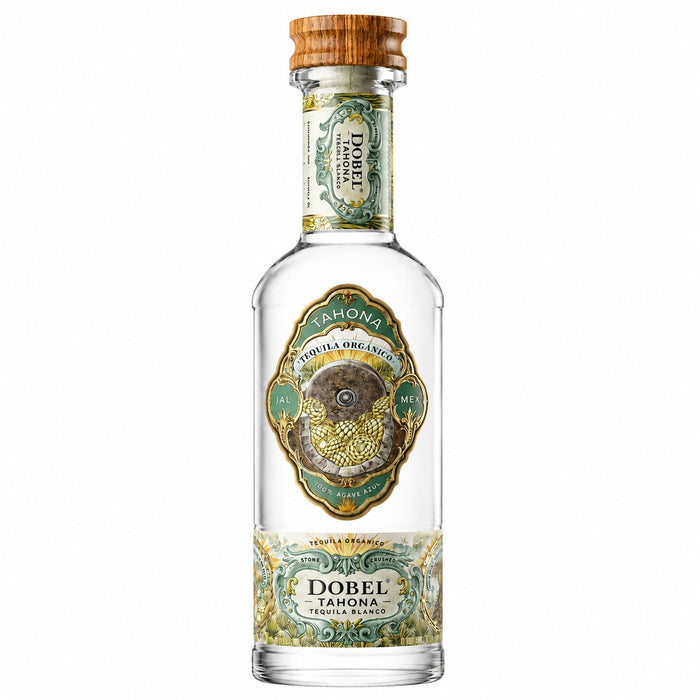 A bottle of Dobel Tahona Tequila Agave Reserve, featuring a clear glass bottle with a light brown wooden cap, and ornate green and gold labels.