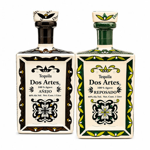 Two bottles of Dos Artes Tequila side by side on a white background. The left bottle is Anejo with a black and cream label, and the right bottle is Reposado with a green and cream label.