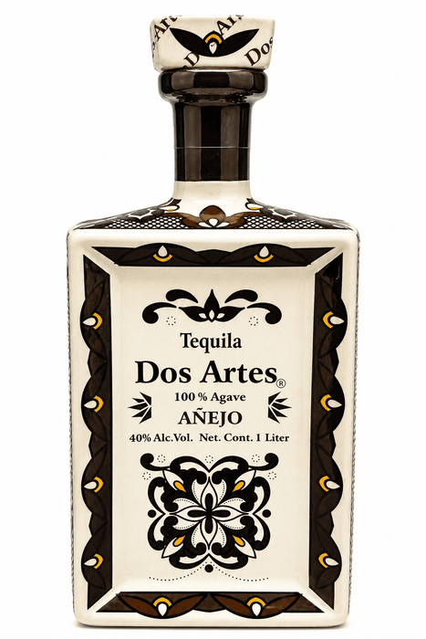 Tequila Dos Artes Anejo bottle with decorative label on a white background