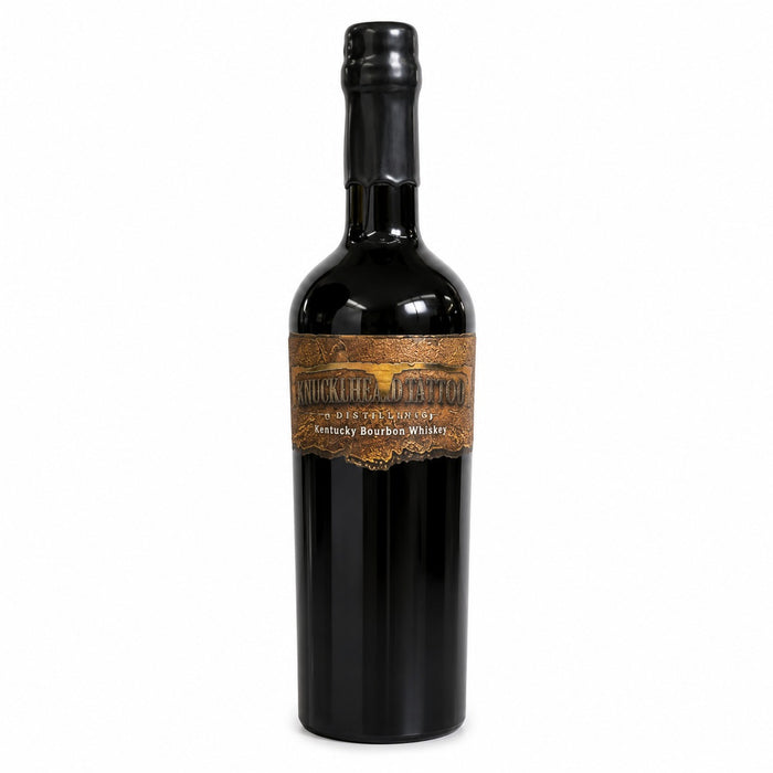 A bottle of Kentucky Bourbon Whiskey with a black glass body, black cap, and a brown label featuring a castle illustration and the text 'MONTES VALLIS Kentucky Bourbon Whiskey on the white back ground