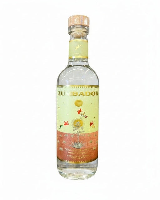 A bottle of Zumbador tequila on a plain white background. The clear glass bottle features a light yellow and orange label with illustrations of birds, a sun, and an agave plant, topped with a cork.