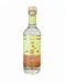 A bottle of Zumbador tequila on a plain white background. The clear glass bottle features a light yellow and orange label with illustrations of birds, a sun, and an agave plant, topped with a cork.