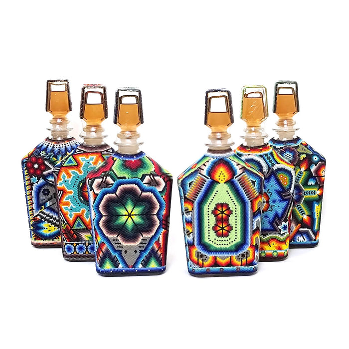 Set of colorful decorative bottles with geometric patterns on a white background