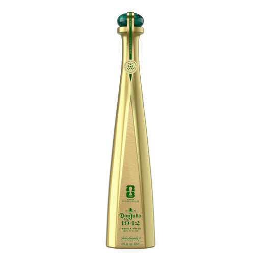 Gold tequila bottle with green cap on a white background